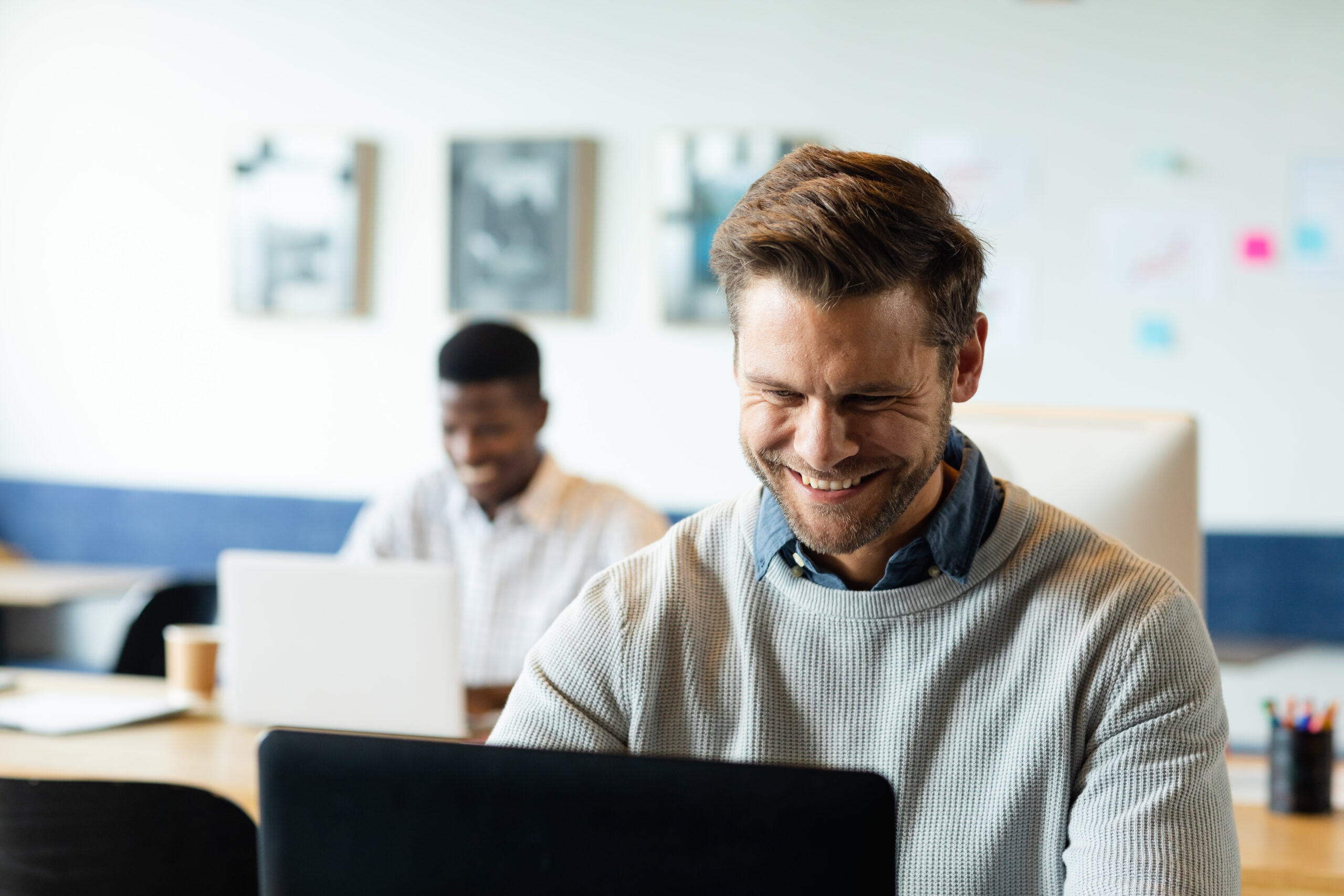 A male employee, with great workplace skills, working happily.